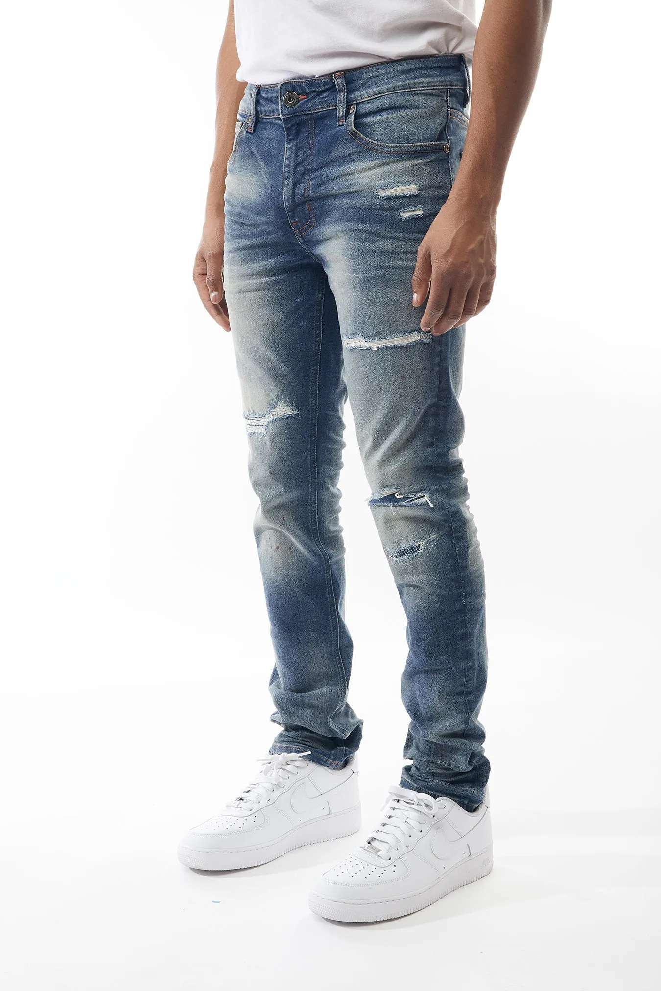 Ripped and Repaired Denim Jeans in Hazy